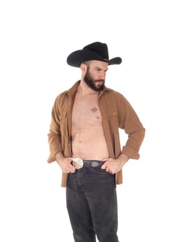 A close up image of a young man in a open brown shirt wearing a.cowboy hat and black jeans, isolated for white background.