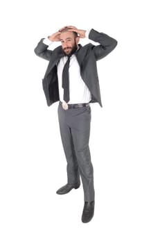 A handsome tall business man standing in a gray suit and tie holding.his hands behind his head, isolated for white background.