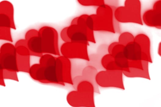 Red hearts bokeh pattern on white background. Love and romance abstract.