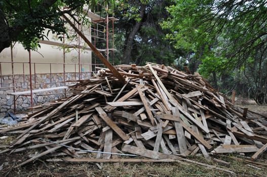 Big pile of old wooden planks at construction site.