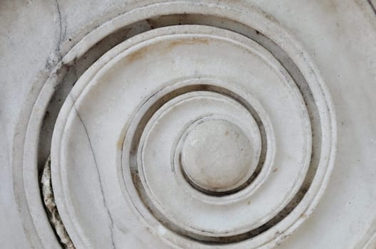 Marble spiral ancient greek ionic column detail. Abstract background.