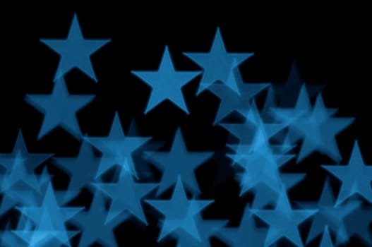 Blue stars pattern abstract blur on black background.