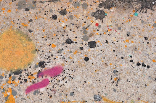 Colorful paint stains on concrete abstract artistic background texture.