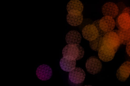 Colorful circles with crosshatch line pattern abstract blur on black background.