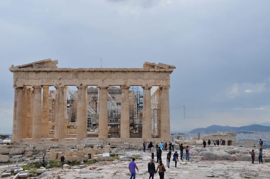 ATHENS, GREECE - MAY 6, 2014: The Parthenon under restoration and people visiting the Acropolis of Athens, Greece.