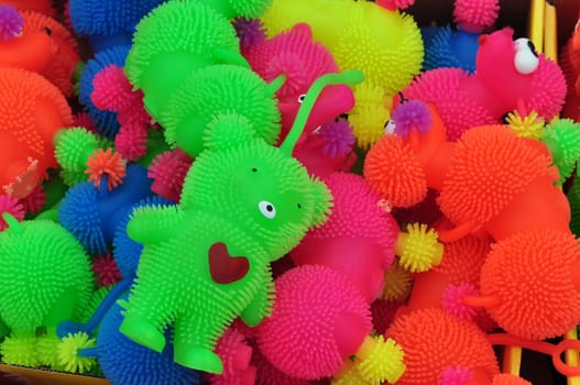 ATHENS, GREECE - AUGUST 15, 2014: Plastic toys and bear with red heart colorful abstract background.