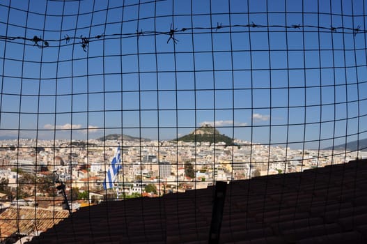 The city of Athens, Greece viewed through fence grid squares background.
