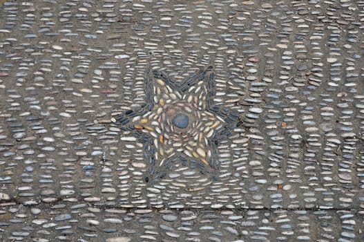 Pebble mosaic with star pattern abstract background.