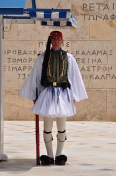 ATHENS, GREECE - JUNE 9, 2014: Evzone soldier with traditional uniform standing guard at the Tomb of the Unknown Soldier in Athens, Greece.