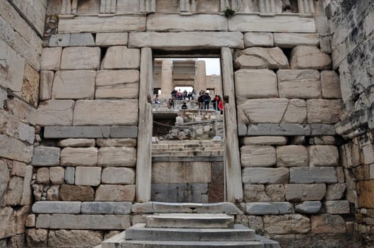 ATHENS, GREECE - MAY 6, 2014: Visitors at the Propylaia and the Beule Gate west entrance to the Acropolis of Athens, Greece.