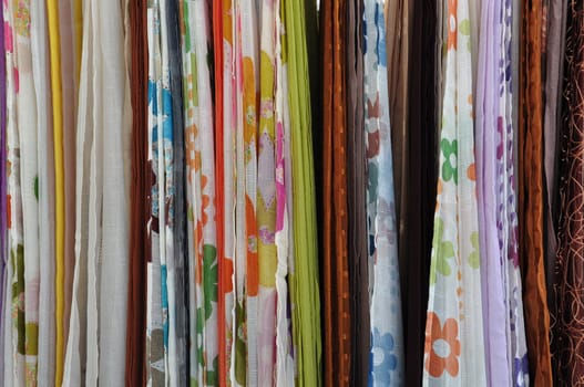 Colorful textiles for sale at street market. Abstract fabric background.