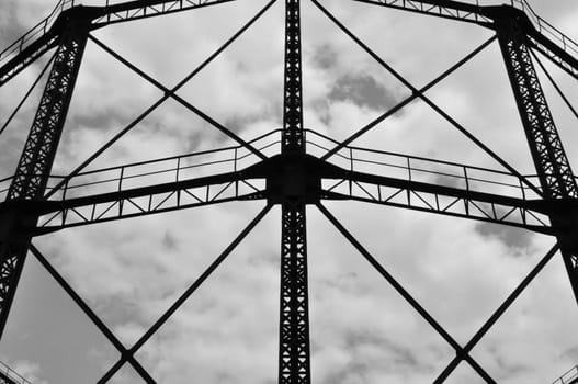 Industrial gasholder frame iron structure exterior abstract architecture. Black and white.