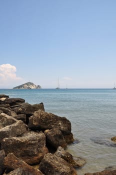 Keri beach summer landscape distant sailboats and island. Zakynthos, Greece.