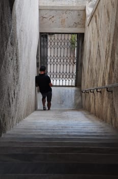 ATHENS, GREECE - SEPTEMBER 2, 2014: Man standing on marble stairs in stoa of attalos at the ancient agora.