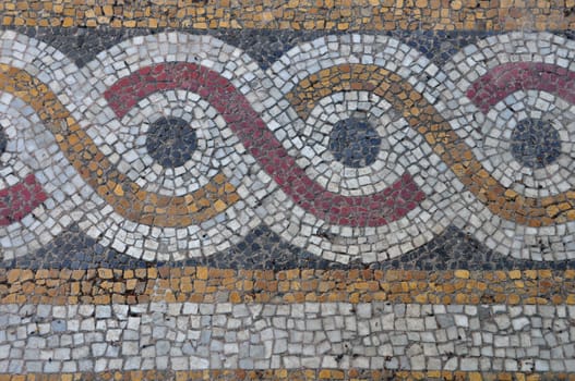 Floor mosaic background with circles pattern abstract geometric design on byzantine era church exterior.
