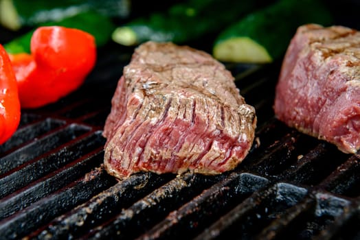 beef steak with different vegetables on barbecue