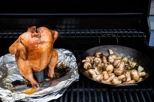 crunchy grilled completely chicken sitting on  barbecue