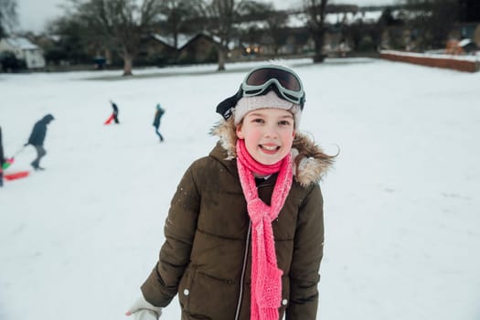 Portrait of a little girl while she is out playing in the snow.