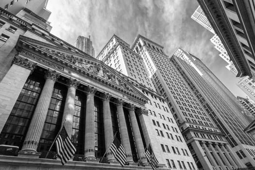 Exterior of New york Stock Exchange, largest stock exchange in world by market capitalization. Wall street, lower Manhattan, New York City, USA. Black and white image.