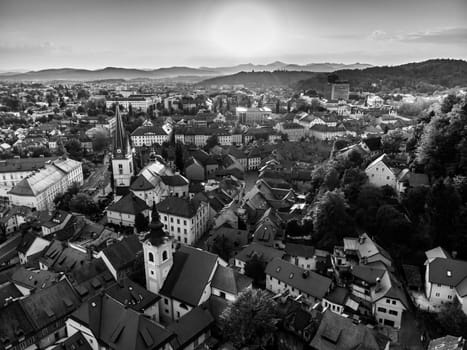 Aerial view of Ljubljana, capital of Slovenia. Roooftops of Ljubljanas old medieval city center seen from Ljubljanas castle at sunset. Black and white image.