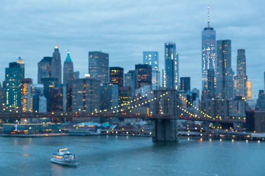 Out of focus image of Brooklyn Bridge and Lower Manhattan skyline at night seen from Manhattan bridge, New York city, USA.