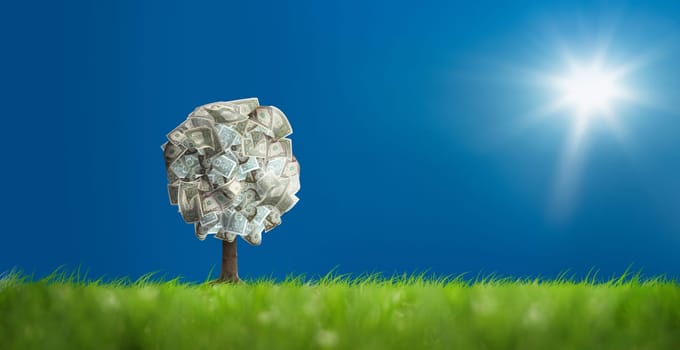 Conceptual image of money tree on green landscape
