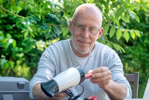 a man repairing a hair dryer for woman