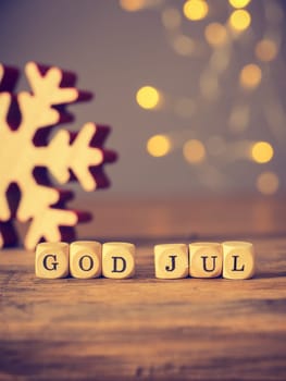 God Jul, Scandinavian Merry Christmas on wooden dices, seasonal background vintage color stylized