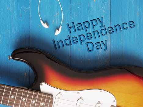 Old vintage guitar on blue wood, Happy independence Day