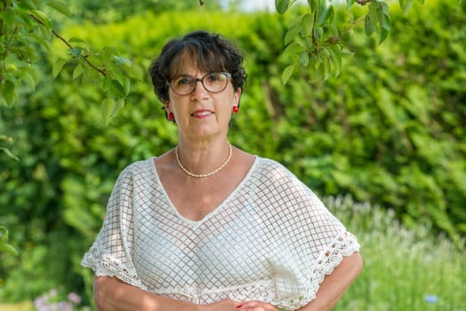 a portrait of a beautiful senior woman in the garden