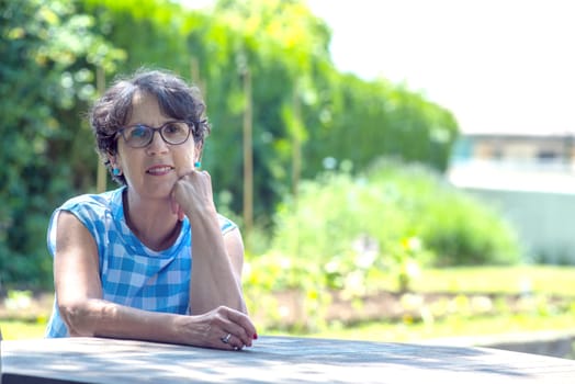 a portrait of a beautiful senior woman in the garden