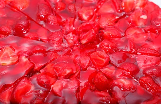 Glsed red strawberries on a strawberry cake,background