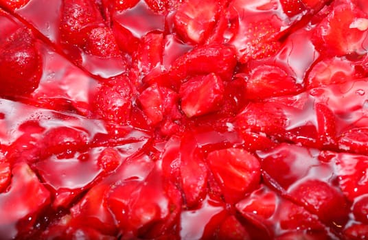 Glsed red strawberries on a strawberry cake,background