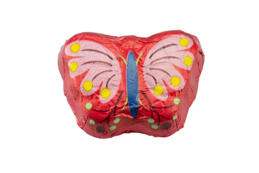 Chocolate butterfly in a colorful packaging on white background isolated. Concept sweets.