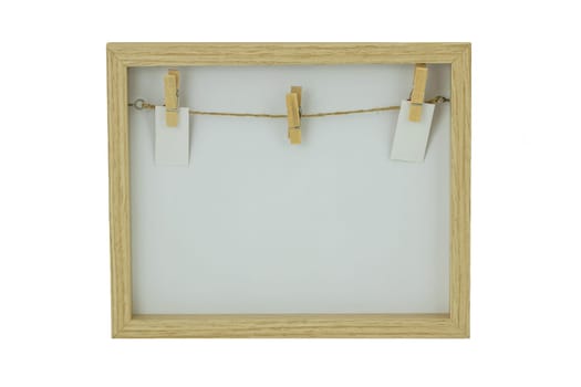 Empty wooden frame with a clothesline and clothespins on the background of frame. Isolated on white background.