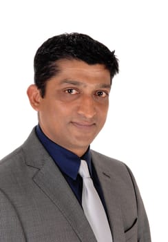 A handsome east Indian businessman in a gray suit and black hair.looking into the camera, isolated for white background.
