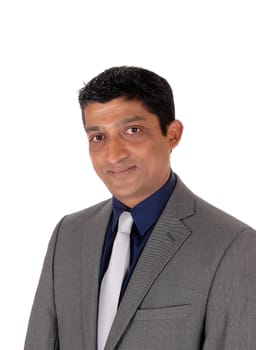 A close up image of the portrait of a east Indian business man in.a gray suit and silver tie, isolated for white background.