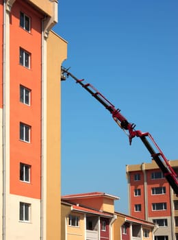 building construction site and crane over blue sky.