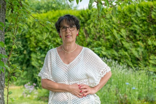 a portrait of a beautiful senior woman in the garden