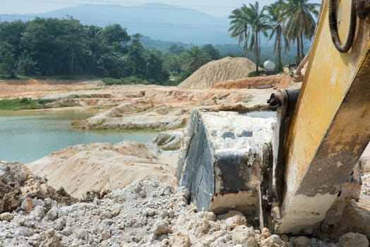 Close up excavator at sand quarry.