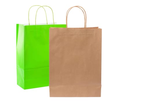 Variety of colored paper shopping bags on white background. Empty area.