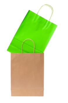 Variety of colored paper shopping bags on white background. Empty area.
