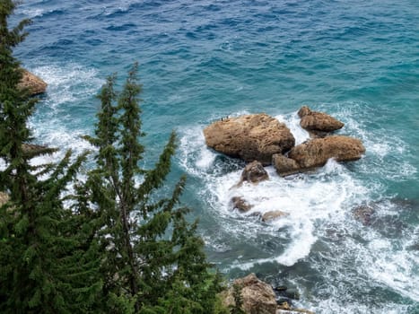 elevated view of rocks in blue water sea and waves in Antalya, Turkey