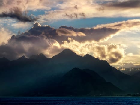 landscape image of high mountains over cloudy sunset sky in Antalya, Turkey.