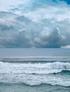 seascape image of waves on sea over stormy sky