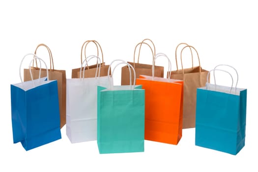 Variety of colored paper shopping bags on white background. Empty area.