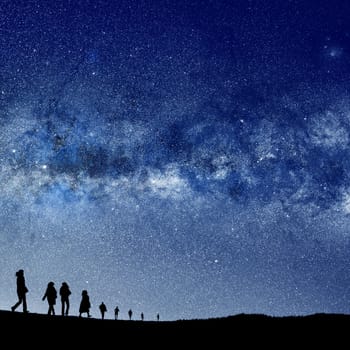 conceptual image of silhouetted people and abstract universe lights. NASA galaxy images manipulated and used https://nasasearch.nasa.gov/search/images?utf8=%E2%9C%93&affiliate=nasa&query=galaxy+images