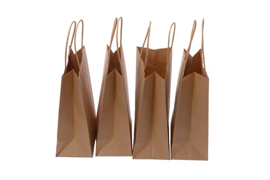 Brown paper shopping bags on white background. Empty area.