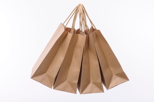 Brown paper shopping bags on white background. Empty area.