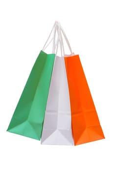 Variety of colored paper shopping bags on white background. Empty area.